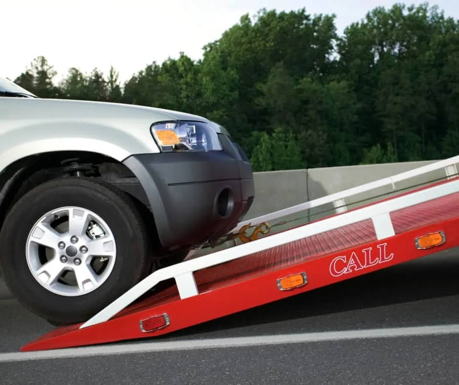 Burlington tow truck loading a vehicle on a residential street